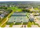 Aerial view of community tennis courts and surrounding landscape at 8015 Willow Brook Dr, Spring Hill, FL 34606