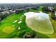 Aerial view of a golf course community with a lake and houses at 8015 Willow Brook Dr, Spring Hill, FL 34606