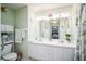 Bright bathroom with double vanity, large mirror, and updated fixtures at 8015 Willow Brook Dr, Spring Hill, FL 34606