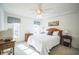 Comfortable bedroom with ceiling fan and plenty of sunlight at 8015 Willow Brook Dr, Spring Hill, FL 34606