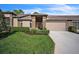 Brick front exterior with attached garage and well-manicured lawn at 8015 Willow Brook Dr, Spring Hill, FL 34606
