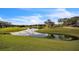 Picturesque golf course with a serene lake and lush landscaping at 8015 Willow Brook Dr, Spring Hill, FL 34606