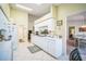 White kitchen with breakfast bar and access to dining and living areas at 8015 Willow Brook Dr, Spring Hill, FL 34606
