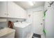 Laundry room with washer, dryer, cabinets, and utility sink at 8015 Willow Brook Dr, Spring Hill, FL 34606
