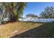 Large fenced backyard with mature trees and grassy area at 9446 Laura Anne Dr, Seminole, FL 33776