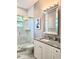 Bathroom features a glass enclosed shower, marble countertop and modern mirror at 122 W Sligh Ave, Tampa, FL 33604