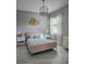 Cozy bedroom featuring a pink bed, stylish lighting, and elegant decor at 122 W Sligh Ave, Tampa, FL 33604