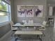 Elegant dining room with modern chandelier, white table with steel legs and chairs at 122 W Sligh Ave, Tampa, FL 33604