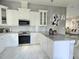 Bright kitchen features white cabinets, granite countertops, and stainless steel appliances at 122 W Sligh Ave, Tampa, FL 33604