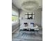 Stylish living room with modern chandelier, white sofa, contemporary art, and grey rug at 122 W Sligh Ave, Tampa, FL 33604