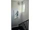 A modern stairway with eye-catching artwork and a unique chandelier at 122 W Sligh Ave, Tampa, FL 33604