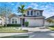 Two-story house with gray siding, a two-car garage, and a landscaped front yard at 12231 Streambed Dr, Riverview, FL 33579