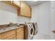 Laundry room with utility sink and ample storage at 12231 Streambed Dr, Riverview, FL 33579