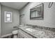 Bathroom with granite countertop, white sink, and white subway tile at 1446 Osceola Hollow Rd, Odessa, FL 33556