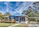 Blue mobile home with deck, screened porch, and carport at 1446 Osceola Hollow Rd, Odessa, FL 33556