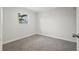 Bedroom featuring neutral colored carpet and a large window offering natural light at 15111 Verona Ave, Clearwater, FL 33760