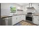 Modern kitchen with white cabinets, stainless steel appliances and marble backsplash at 15111 Verona Ave, Clearwater, FL 33760
