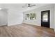 Bright living room with hardwood floors, ceiling fan and large windows at 15111 Verona Ave, Clearwater, FL 33760