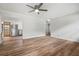 Open living room with hardwood floors and a view of the kitchen at 15111 Verona Ave, Clearwater, FL 33760