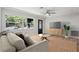 Living room with hardwood floors, a ceiling fan and staged furniture at 15111 Verona Ave, Clearwater, FL 33760