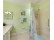 Clean bathroom with a tub shower, updated vanity, and seashell decor at 1719 S Pebble Beach Blvd, Sun City Center, FL 33573