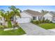 Two-story home with a two-car garage and a nicely landscaped yard at 1814 W Palms Dr, Port Charlotte, FL 33953