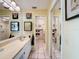 Bright bathroom with a white vanity, mirrored cabinets, and tiled floor with shower at 2281 Lake Arbor Blvd, Clearwater, FL 33763