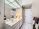Bathroom with double sink vanity and view of kitchen at 2281 Lake Arbor Blvd, Clearwater, FL 33763