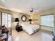 Comfortable bedroom with a ceiling fan, ample natural light, and a serene ambiance for relaxation at 2281 Lake Arbor Blvd, Clearwater, FL 33763