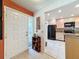 Welcoming entryway featuring a white front door and view into the updated kitchen with modern, stainless steel appliances at 2281 Lake Arbor Blvd, Clearwater, FL 33763