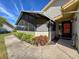 Charming front porch with a screened-in enclosure, beautiful landscaping, and a welcoming entrance at 2281 Lake Arbor Blvd, Clearwater, FL 33763