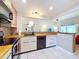 Contemporary kitchen with updated appliances, light wood cabinets, and a stylish backsplash at 2281 Lake Arbor Blvd, Clearwater, FL 33763