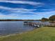 Serene lakefront view with a wooden dock at 2281 Lake Arbor Blvd, Clearwater, FL 33763