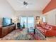 Bright living room with vaulted ceilings, large windows, and a colorful area rug adding warmth to the space at 2281 Lake Arbor Blvd, Clearwater, FL 33763