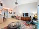 Open-concept living area with high ceilings, a ceiling fan, and seamless access to the dining area and kitchen at 2281 Lake Arbor Blvd, Clearwater, FL 33763
