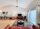 Spacious living room featuring vaulted ceilings, a large window, and an open layout perfect for entertaining at 2281 Lake Arbor Blvd, Clearwater, FL 33763