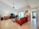 Cozy living room with vaulted ceilings, a colorful rug, and sliding glass doors providing natural light at 2281 Lake Arbor Blvd, Clearwater, FL 33763