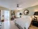 Relaxing main bedroom with ample natural light, ceiling fan, and a decorative mirror accent at 2281 Lake Arbor Blvd, Clearwater, FL 33763