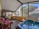Enclosed patio features a jacuzzi tub and comfortable seating, creating an ideal space for relaxation at 2281 Lake Arbor Blvd, Clearwater, FL 33763