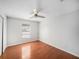 Simple bedroom with hardwood floors and a ceiling fan at 2308 Long Green Ct, Valrico, FL 33596