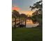 Picturesque gazebo and dock at sunset over lake at 2679 Sabal Springs Cir # 203, Clearwater, FL 33761