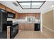 Kitchen boasts wood cabinets, black appliances, and a view to the backyard at 2679 Sabal Springs Cir # 203, Clearwater, FL 33761