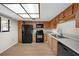 Kitchen features wood cabinets, black appliances, and light flooring at 2679 Sabal Springs Cir # 203, Clearwater, FL 33761