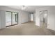 Large main bedroom featuring neutral tones, carpet flooring, and access to a screened in porch at 2679 Sabal Springs Cir # 203, Clearwater, FL 33761