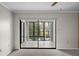 Bright sunroom features large glass windows and tiled floors, offering serene outdoor views at 2679 Sabal Springs Cir # 203, Clearwater, FL 33761
