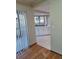 View into the kitchen with white cabinetry and a breakfast bar at 3536 Countrybrook Ln # 13, Palm Harbor, FL 34684