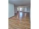 Open living room with wood-look laminate flooring and natural light at 3536 Countrybrook Ln # 13, Palm Harbor, FL 34684