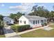 White house with a gray roof, surrounded by a well-maintained lawn and shrubs at 4512 70Th N St, St Petersburg, FL 33709