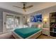 Bright bedroom with a ceiling fan and teal bedding at 4809 S Mound Ave # 201, Tampa, FL 33611