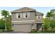 Two-story house with gray siding, shutters, and a two-car garage at 5017 Rocky Coast Pl, Palmetto, FL 34221